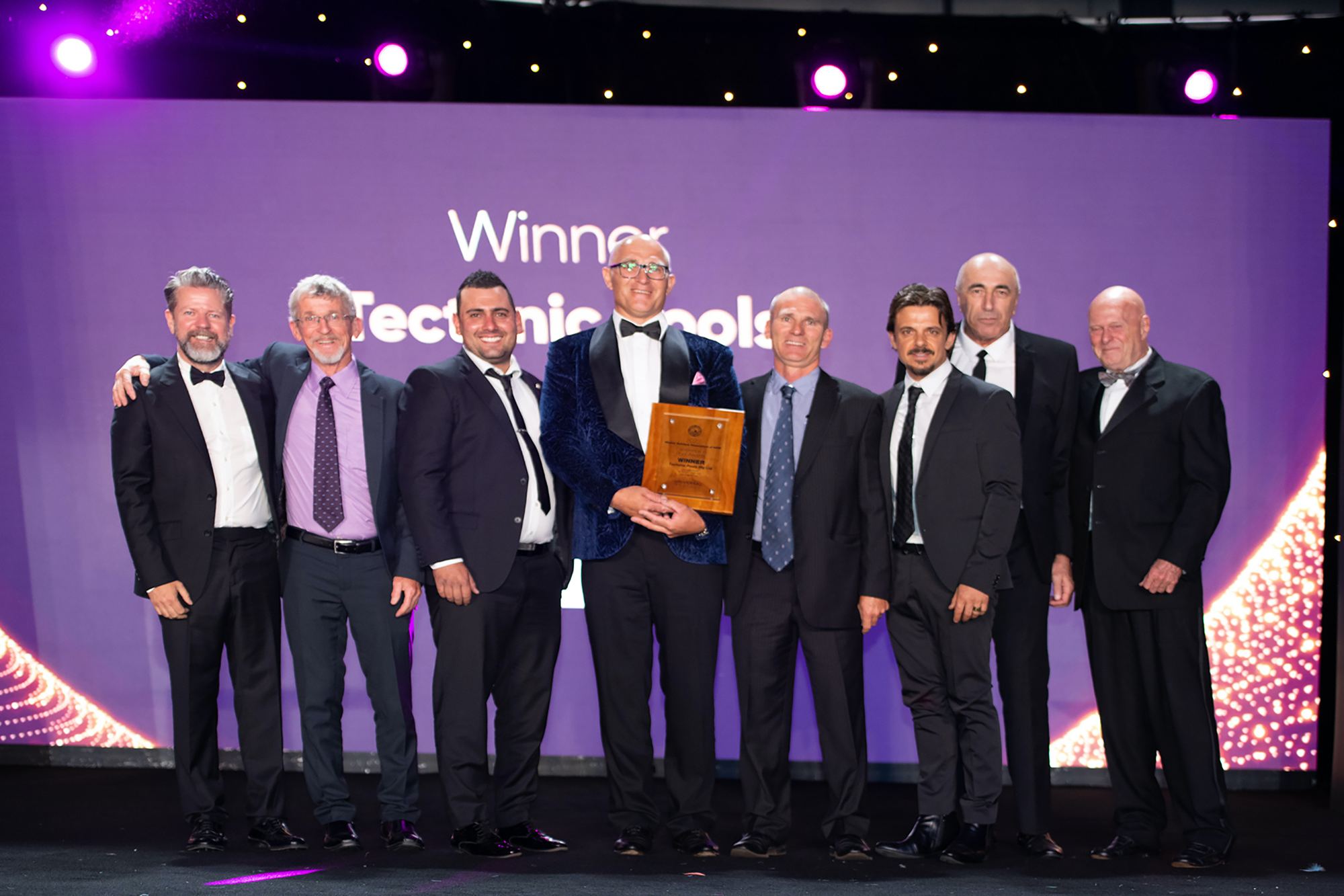 Team Tectonic accepting an award on stage at an industry awards night